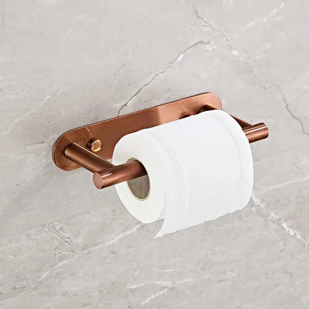 Rose-gold rotating toilet paper holder mounted on marble tile