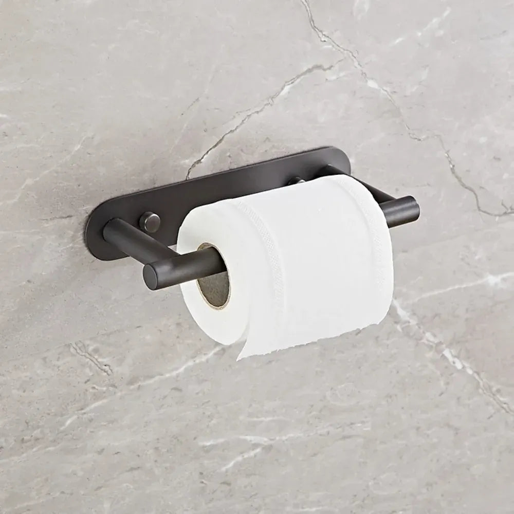 Black rotating toilet paper holder mounted on marble tile