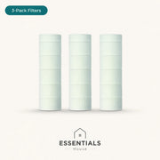 Three white cylindrical replacement filters standing upright on a light beige background, with a teal '3-Pack Filters' label at the top left and the 'ESSENTIALS House' logo at the bottom.
