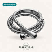 A coiled stainless steel shower hose with metal connectors, shown on a light beige background with a teal 'Stainless Steel' label and the 'ESSENTIALS House' logo at the bottom.