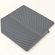 Silicone Dish Drying Mat on a warm off-white background with a soft natural shadow.
