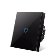 Black glass-panel touch light switch with one blue circular touch button, shown at an angle on a white background.