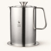 Stainless Steel Cooking Oil Filter Pot on a warm off-white background with a soft natural shadow.
