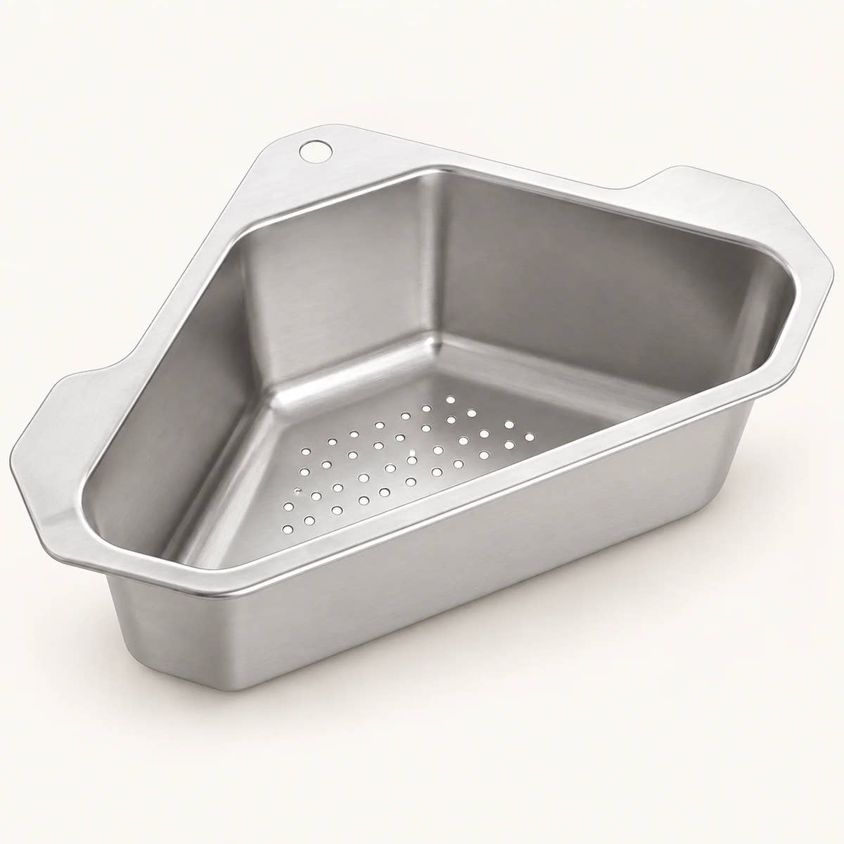 Stainless Steel Corner Sink Basket on a warm off-white background with a soft natural shadow.