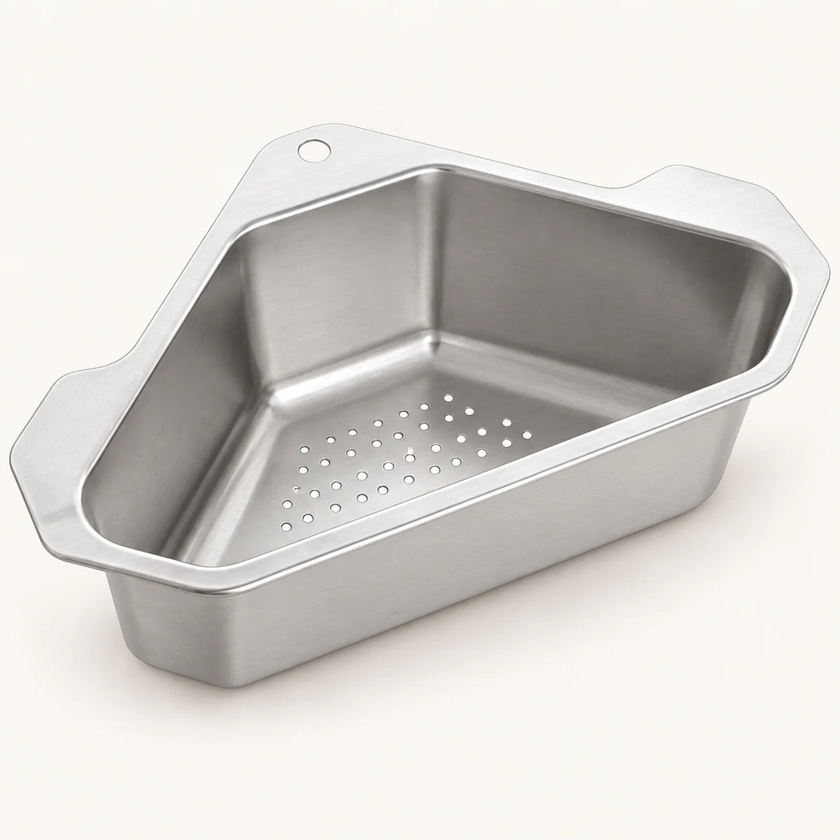 Stainless Steel Corner Sink Basket on a warm off-white background with a soft natural shadow.