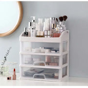 Clear makeup and jewelry organizer beside a vanity mirror