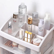 Top tray of clear organizer holding skincare and perfume bottles