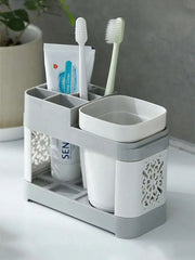Gray toothbrush holder with two rinse cups and toothbrush slots