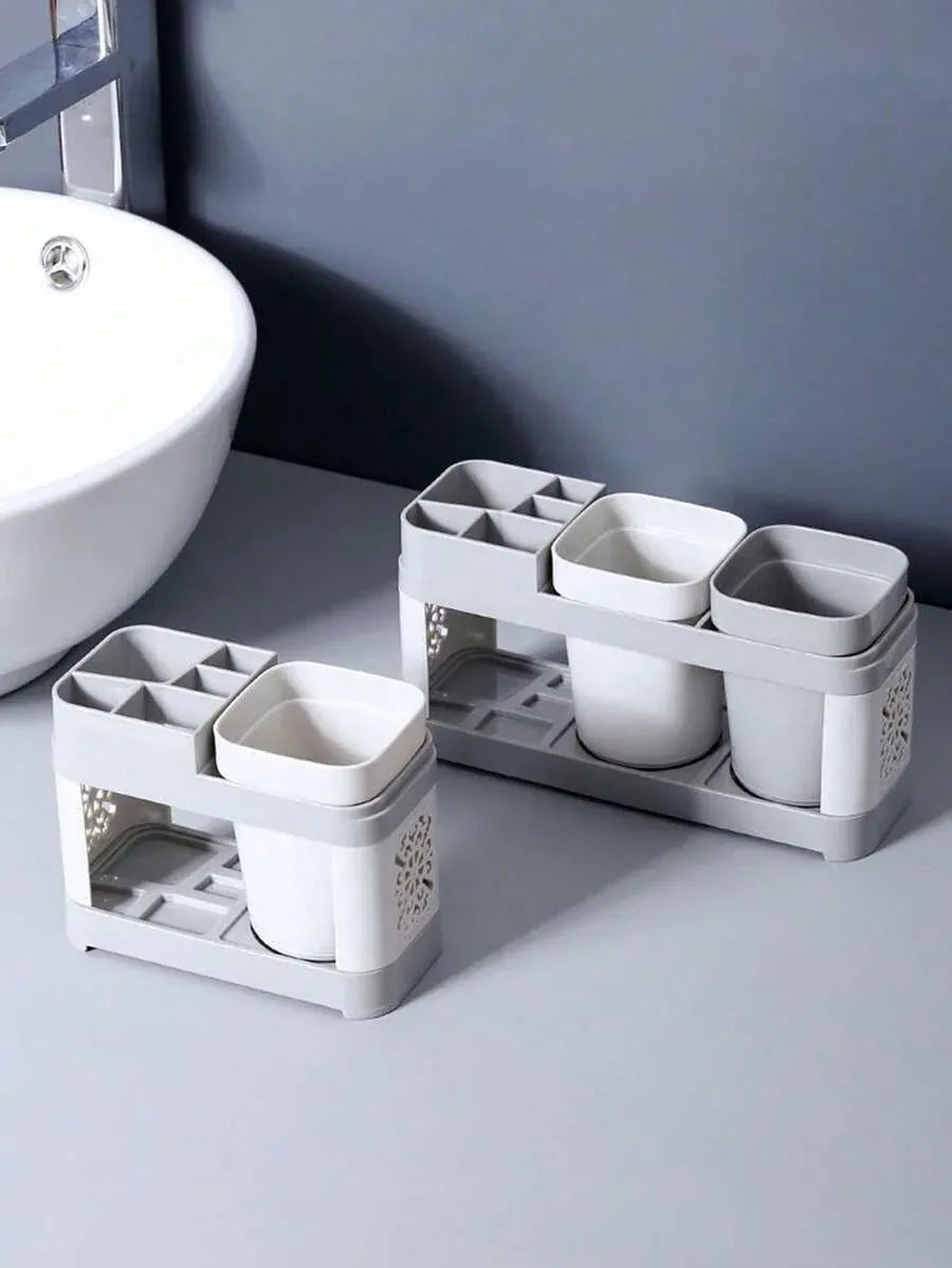 Compact gray toothbrush holder beside a bathroom sink