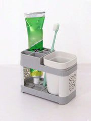 Gray toothbrush holder storing toothpaste and a toothbrush