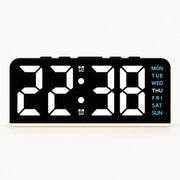 Black USB digital alarm clock with white digits, blue weekday labels and a light strip along its base.