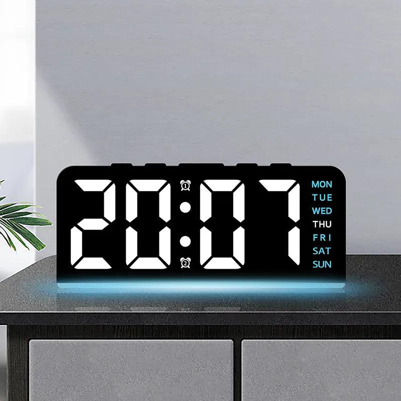 Digital alarm clock with white digits and blue mood light on a cabinet