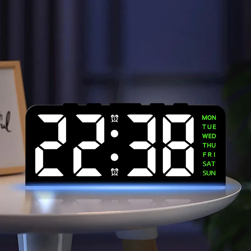 Digital alarm clock with white digits and green weekday labels on a round bedside table