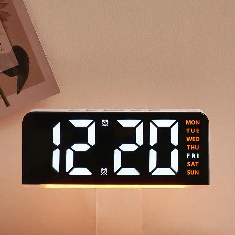 Digital alarm clock with white digits, orange weekday labels and orange mood light