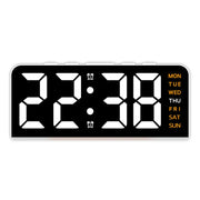 White case digital alarm clock with white digits and orange weekday labels