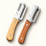 Stainless Steel Vegetable Peeler with Wood Handle on a warm off-white background with a soft natural shadow.