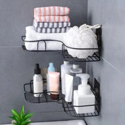 Black corner shelves holding towels and toiletries