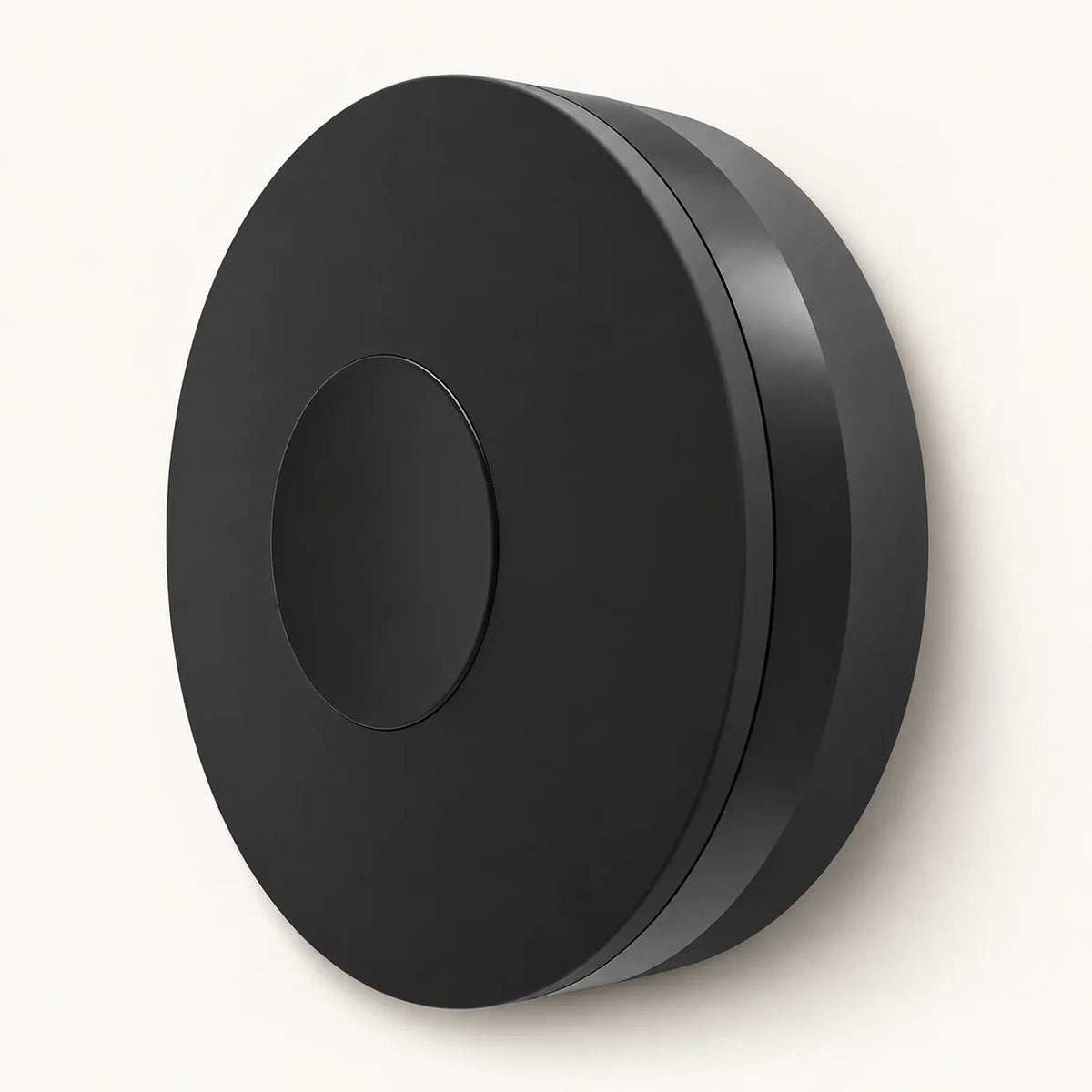Single black circular WiFi IR/RF remote hub shown at an angle on a warm off-white background.